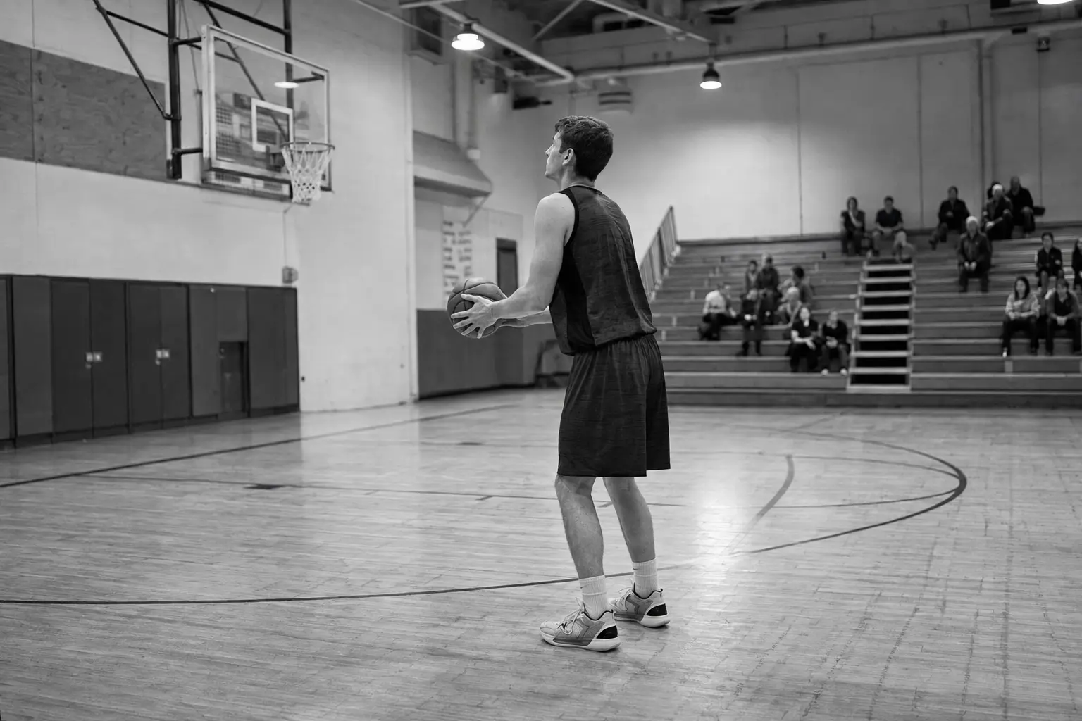 White male basketball athlete preparing for a free throw in a naturally lit gym